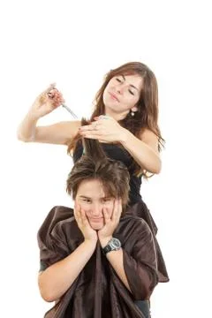 Disappointed boy with face expression with long hair at hairdresser Stock Photos