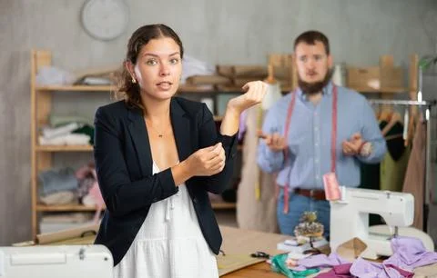 Disappointed customer reacting to defect in custom-made jacket Stock Photos