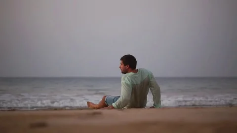 Disappointed depressed lost man coming to life and getting up. Desert island. Stock Footage 80444291