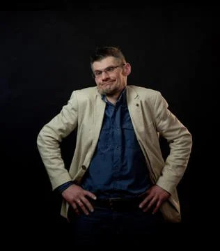 Disappointed guy in white jacket and glasses breathes deeply Stock Photos