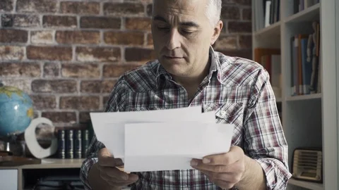 Disappointed man checking his home finances Stock Footage 103203221