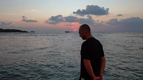 Disappointed man shaking head facing ocean in maldives Stock Footage 279839790