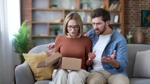 Disappointed married couple received a parcel with wrong product after opening  Stock Footage 337929900