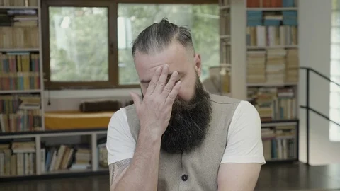 Disappointing reaction of a young mean with beard running fingers through his Stock Footage 90555043