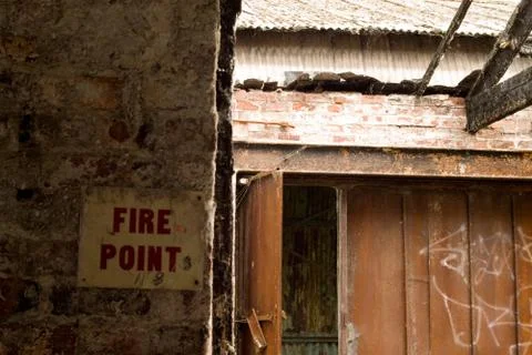 The disarray of a demolished building with a sign on the wall that says "Fire Stock Photos