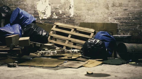 Disarray of discarded materials in a dimly lit urban space Stock Footage 330171646