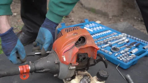Disassemble a broken brush cutter Stock Footage 268973285