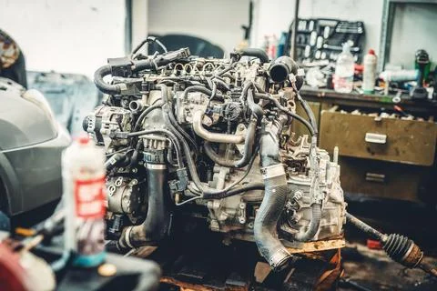 Disassemble the engine from the car in the car workshop. Stock Photos