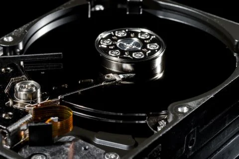Disassembled and opened hard disk drive, inside view with reflections, isolat Foto stock