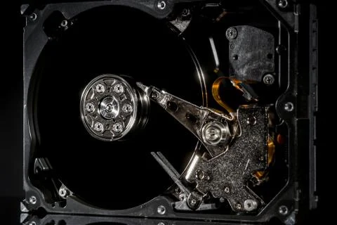 Disassembled and opened hard disk drive, inside view with reflections, isolat Foto stock