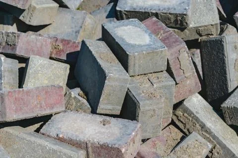 Disassembled building bricks stacked in a large pile close up Foto stock