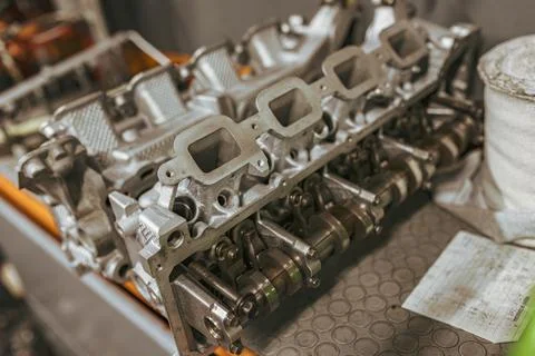 Disassembled car engine lying on table in workshop Stock Photos
