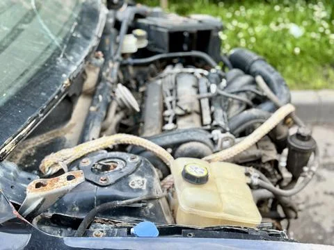 Disassembled Car Engine Showcasing Its Exposed Components Awaiting Repairs and Stock Photos