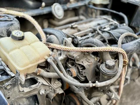 Disassembled Car Engine Showcasing Its Exposed Components Awaiting Repairs and Stock Photos
