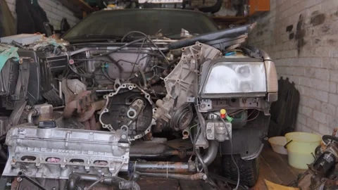 Disassembled car engine undergoing repair in garage Stock Footage 304120289