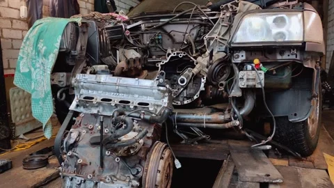 Disassembled car engine undergoing repair in garage Видео 304120519