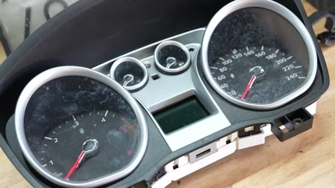 Disassembled car instrument cluster on workshop bench Stock Footage 321938852