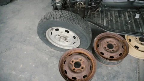 Disassembled car, old and colored car wheel disk Stock Footage 86296351
