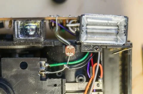 Disassembled compact camera. Internal parts of the broken camera being repaired Stock Photos