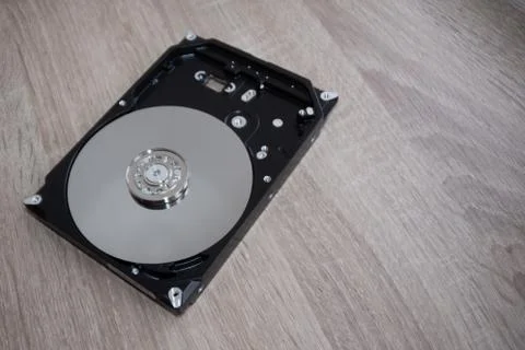 Disassembled computer hard drive device close-up. Dismantling inspection clea Stock Photos