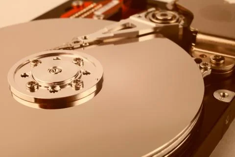 Disassembled computer hard drive with mirror disks. Toned orange color Stock Photos