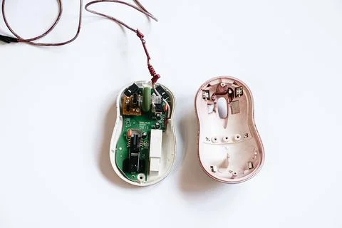 Disassembled computer mouse on white background. Gadget repair. Stock Photos