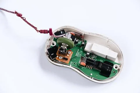 Disassembled computer mouse on white background. Gadget repair. Stock Photos