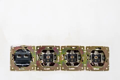 Disassembled electrical sockets in plastered wall Stock Photos