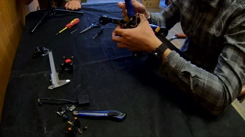 Disassembled FPV quadrocopter, do-it-yourself drone repair on a black table Stock Footage 168279441
