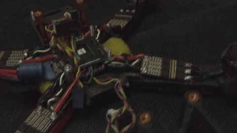 Disassembled FPV quadrocopter, do-it-yourself drone repair on a black table Stock Footage 168279546