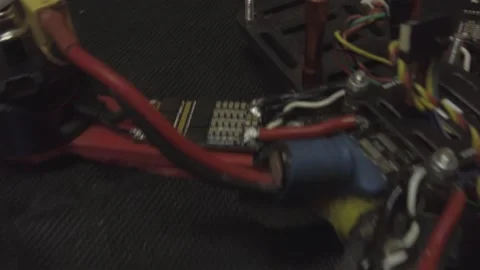 Disassembled FPV quadrocopter, do-it-yourself drone repair on a black table Stock Footage 168279576