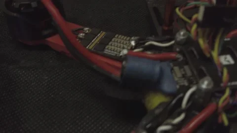 Disassembled FPV quadrocopter, do-it-yourself drone repair on a black table Stock Footage 168279622