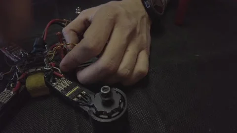 Disassembled FPV quadrocopter, do-it-yourself drone repair on a black table Stock Footage 168279798