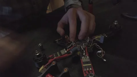 Disassembled FPV quadrocopter, do-it-yourself drone repair on a black table Stock Footage 168279817
