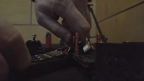 Disassembled FPV quadrocopter, do-it-yourself drone repair on a black table Stock Footage 168280002