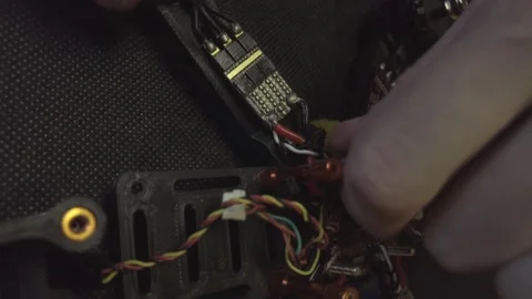 Disassembled FPV quadrocopter, do-it-yourself drone repair on a black table Stock Footage 168280075
