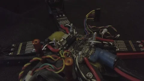 Disassembled FPV quadrocopter, do-it-yourself drone repair on a black table Stock Footage 168280152