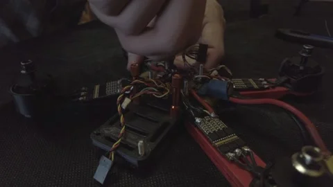 Disassembled FPV quadrocopter, do-it-yourself drone repair on a black table Stock Footage 168280203