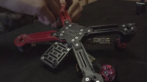 Disassembled FPV quadrocopter, do-it-yourself drone repair on a black table Stock Footage 168280415