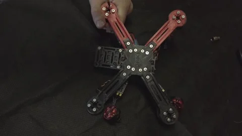 Disassembled FPV quadrocopter, do-it-yourself drone repair on a black table Stock Footage 168280483