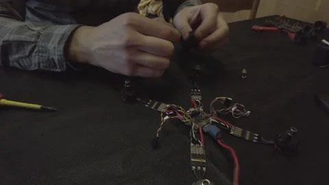 Disassembled FPV quadrocopter, do-it-yourself drone repair on a black table Stock Footage 168280683