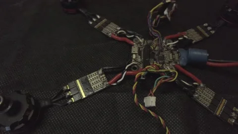 Disassembled FPV quadrocopter, do-it-yourself drone repair on a black table Stock Footage 168280760