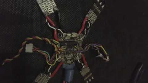 Disassembled FPV quadrocopter, do-it-yourself drone repair on a black table Stock Footage 168280775