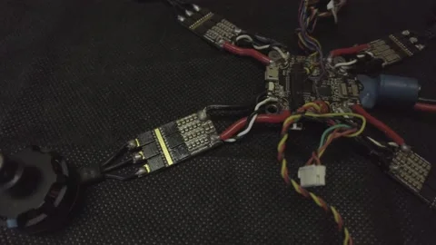 Disassembled FPV quadrocopter, do-it-yourself drone repair on a black table Stock Footage 168280800