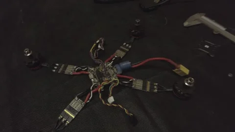 Disassembled FPV quadrocopter, do-it-yourself drone repair on a black table Stock Footage 168280831