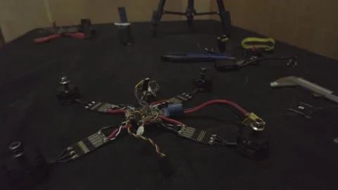 Disassembled FPV quadrocopter, do-it-yourself drone repair on a black table Stock Footage 168280875