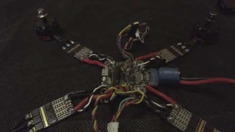 Disassembled FPV quadrocopter, do-it-yourself drone repair on a black table Stock Footage 168280878