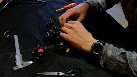 Disassembled FPV quadrocopter, do-it-yourself drone repair on a black table Stock Footage 168281144