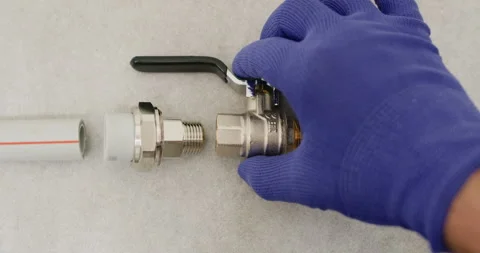 Disassembled layout shows valve between two pipe unions Stock Footage 322009384