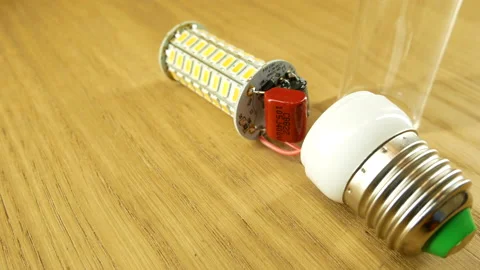 The disassembled LED corn lamp is on the table. Base E27 Stock Footage 132315122